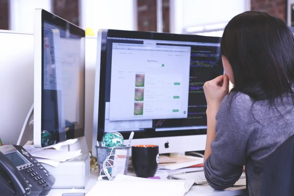 Website owner reviewing pages on a monitor during a quick SEO audit