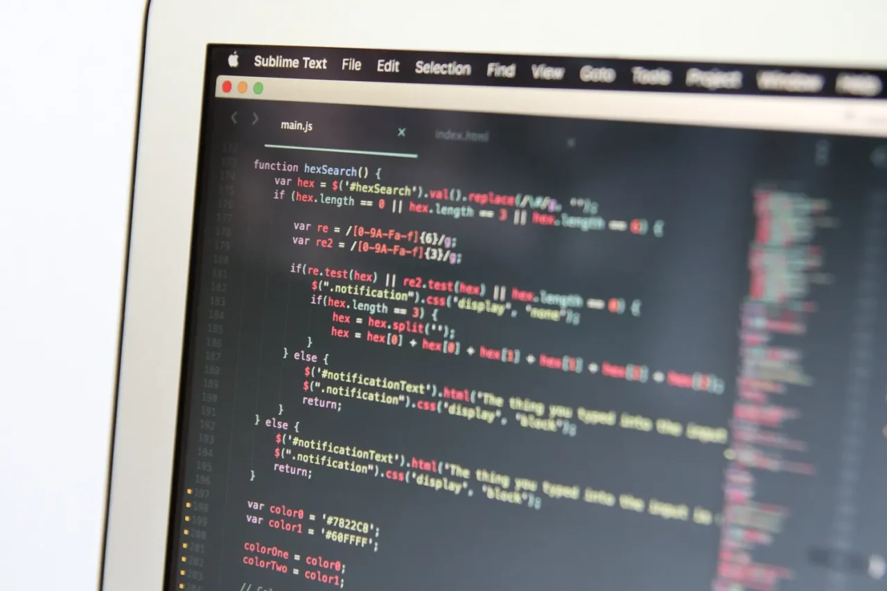 Close-up of HTML and JavaScript code on a laptop screen for canonical URL setup