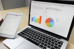 Laptop showing charts and a tablet calendar, used to plan and track a website SEO audit
