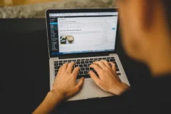 Blogger typing on a laptop during a weekly SEO routine